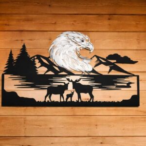 Custom CNC plasma-cut 1/8 inch steel wall art of a white bald eagle head and a family of moose (two adults and a calf) standing by a lake with a mountain and forest backdrop.