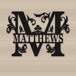 Matte black personalized floral split monogram metal sign displayed on a light wood wall